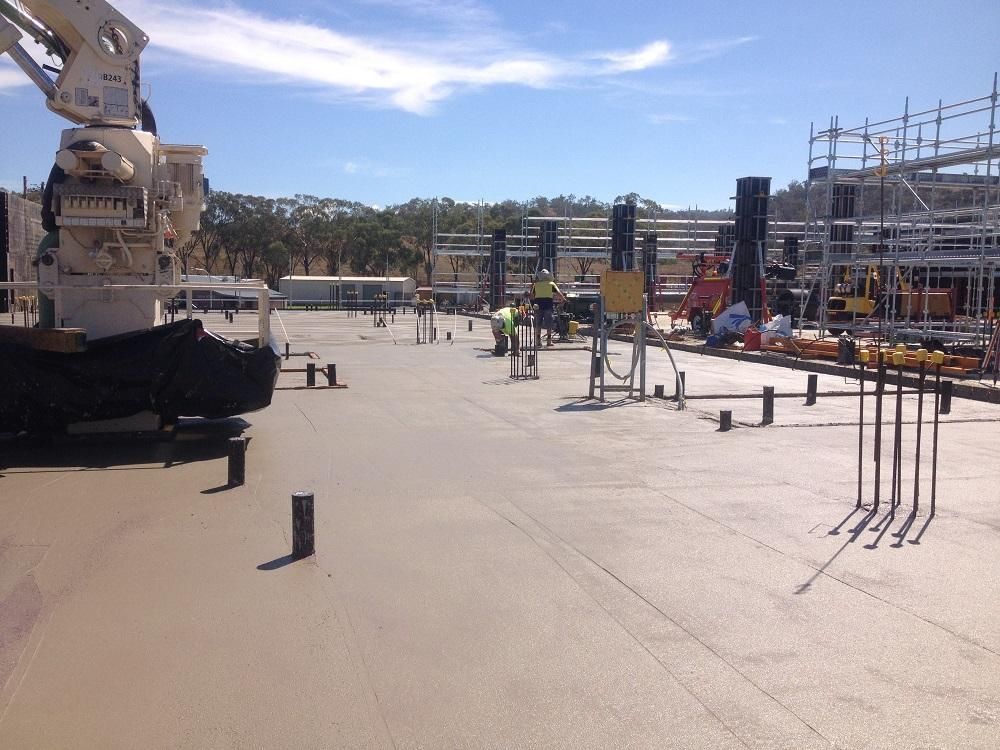 A Construction Site With A Crane In The Middle Of It — New England & North West Concrete Pumping In Uralla, NSW