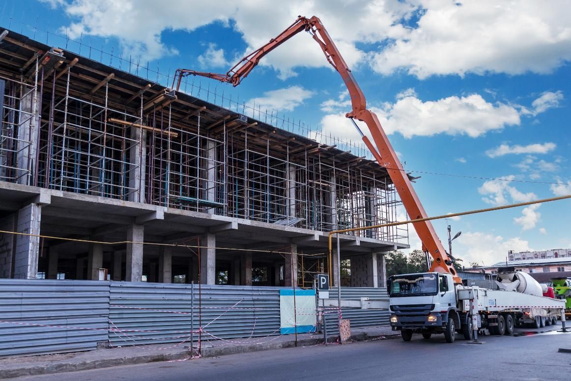 A Concrete Pump Is Being Used To Pour Concrete Into A Building — New England & North West Concrete Pumping In Uralla, NSW