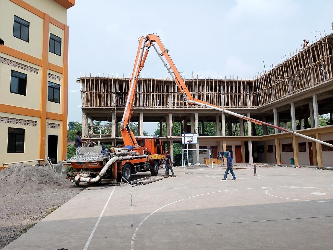 A Concrete Pump Is Being Used To Pour Concrete — New England & North West Concrete Pumping In Uralla, NSW