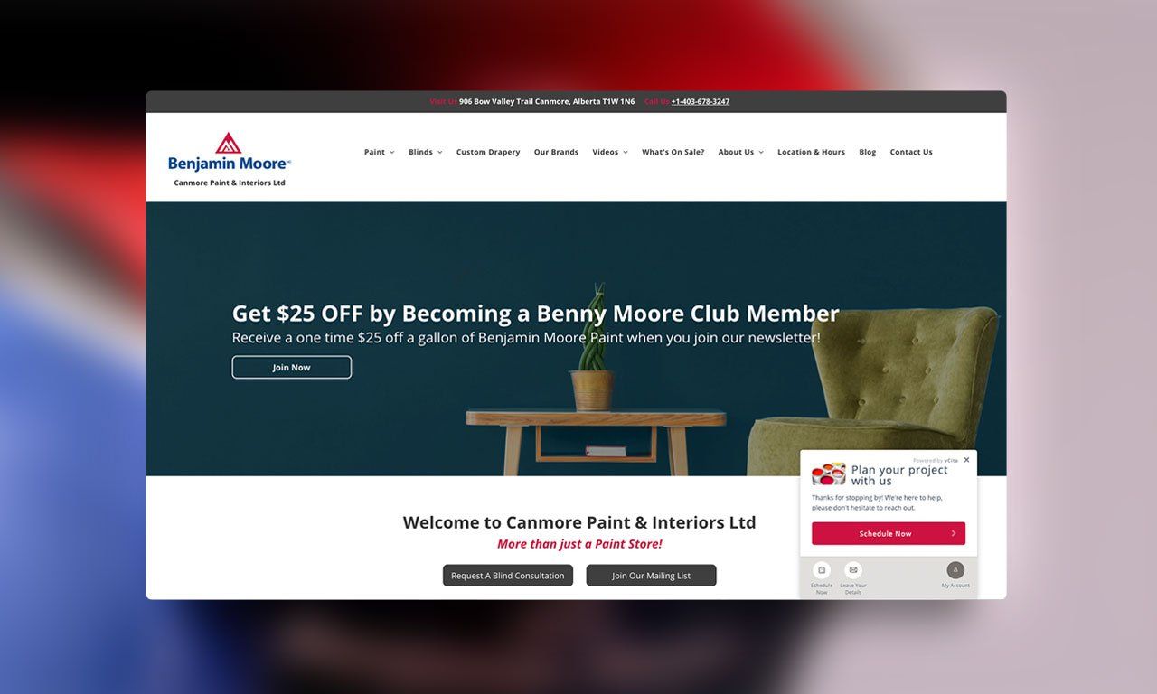 A computer screen shows a website with a table and chair on it.