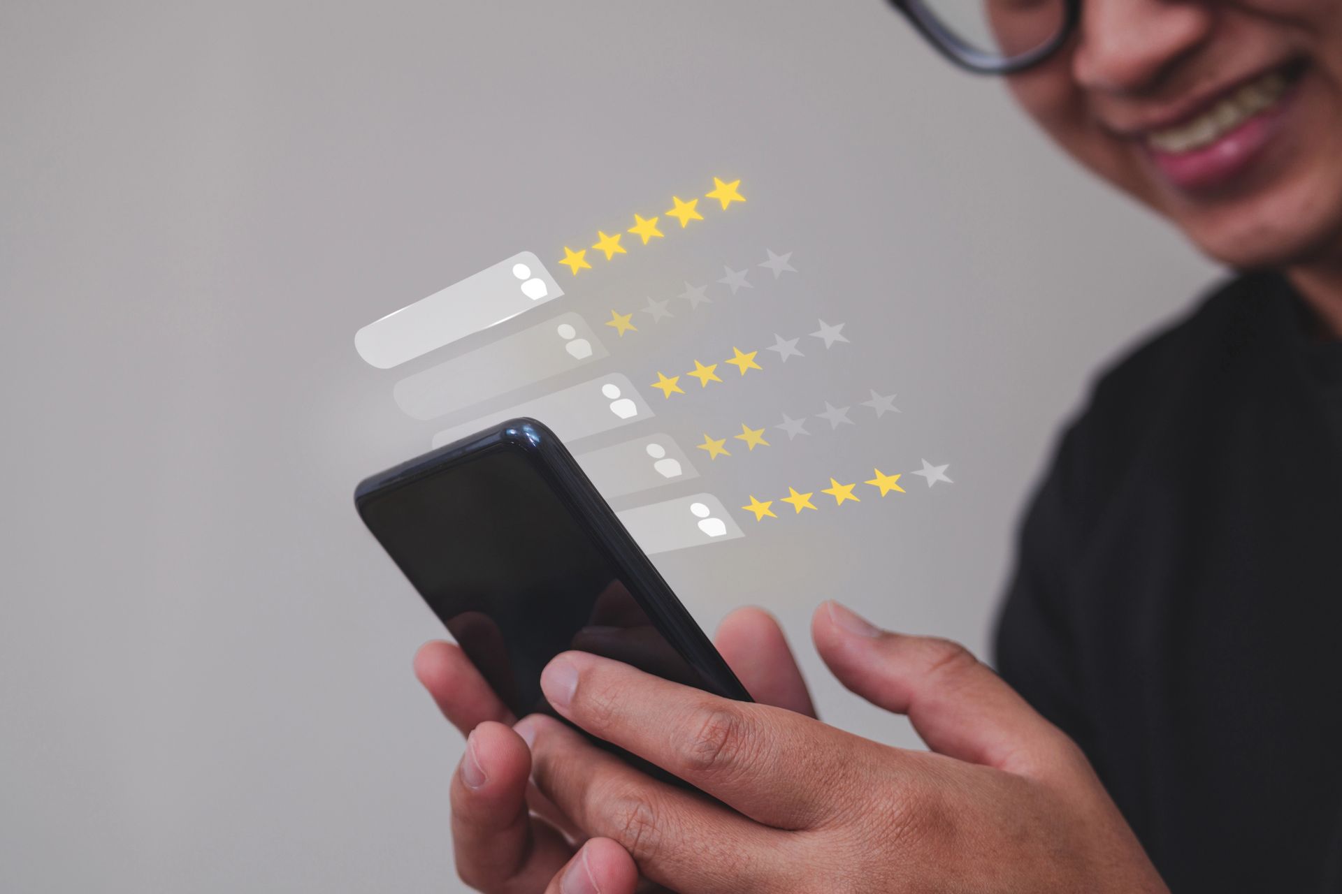 Person smiling, using phone, reviewing ratings represented by stars.