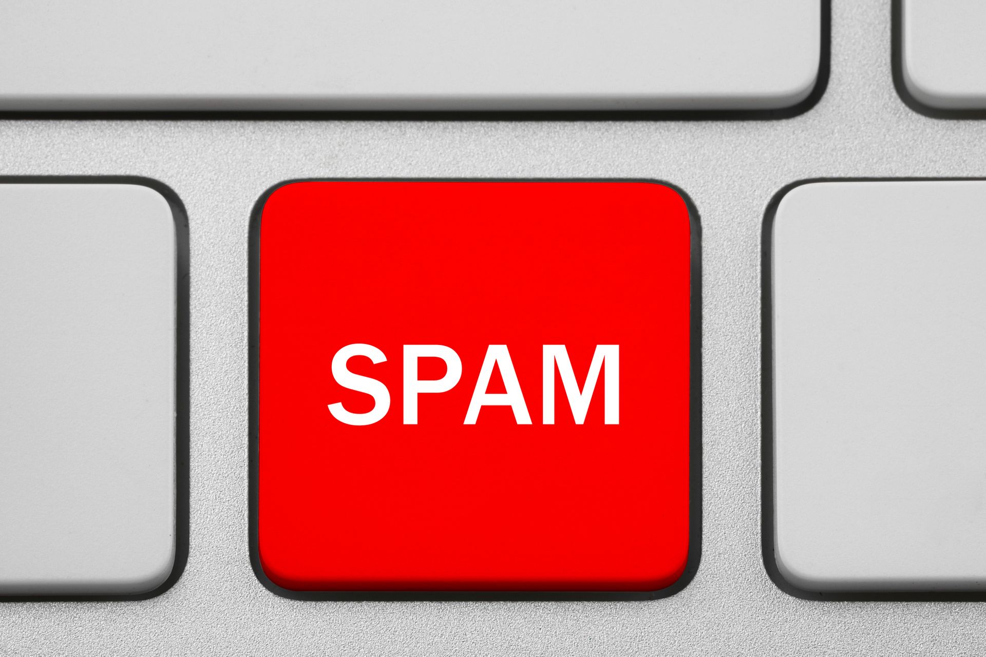 The word spam is on a red button on a keyboard.