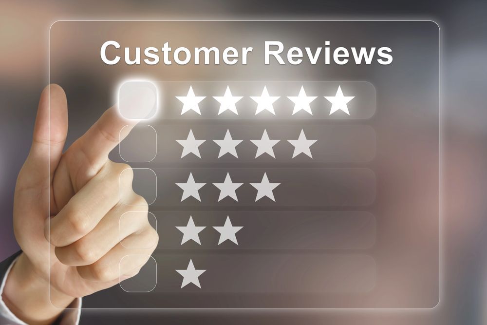 Hand touching a digital screen to select a five-star customer review rating.