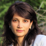 A close up of a woman 's face with a gray shirt on