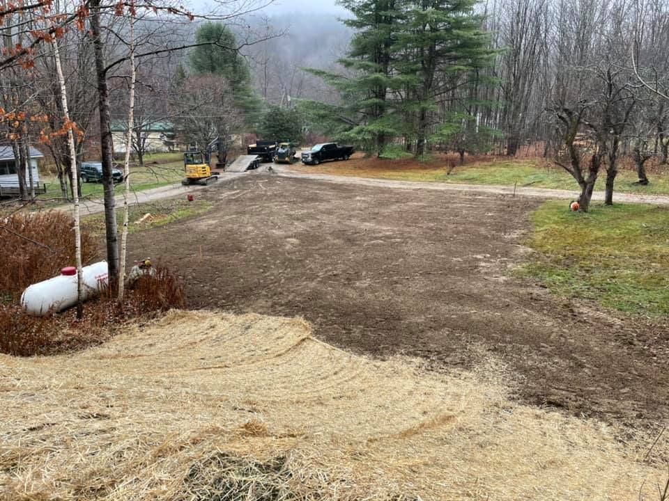 A propane tank is sitting in the middle of a dirt road.