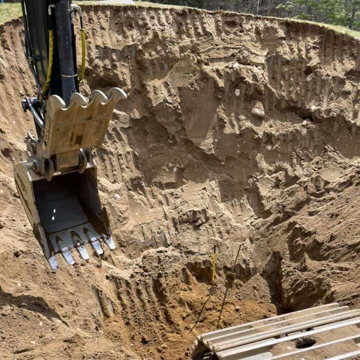 An excavator is digging a hole in the ground
