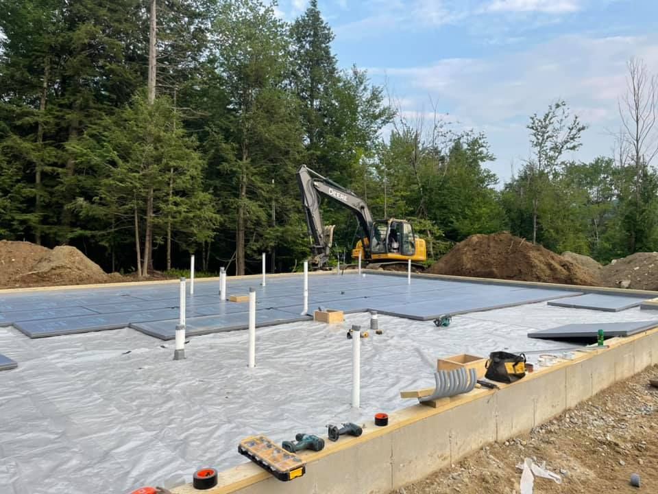 A construction site with a bulldozer in the background.