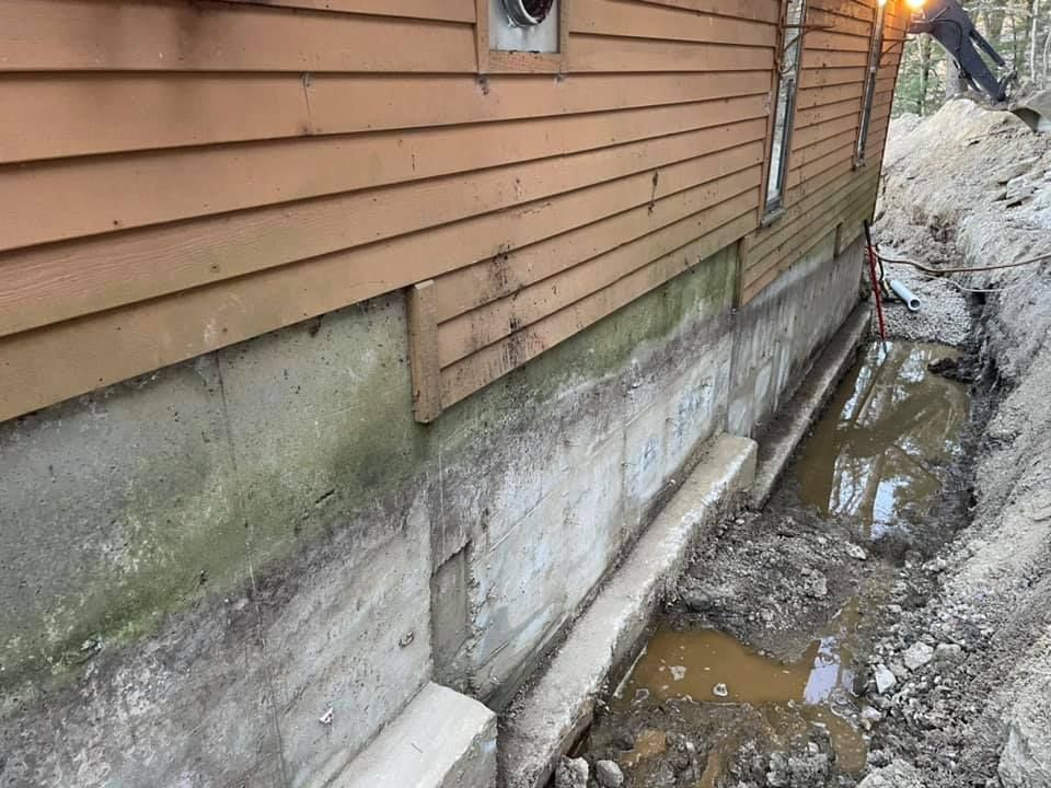 A house with a concrete foundation and a wooden siding