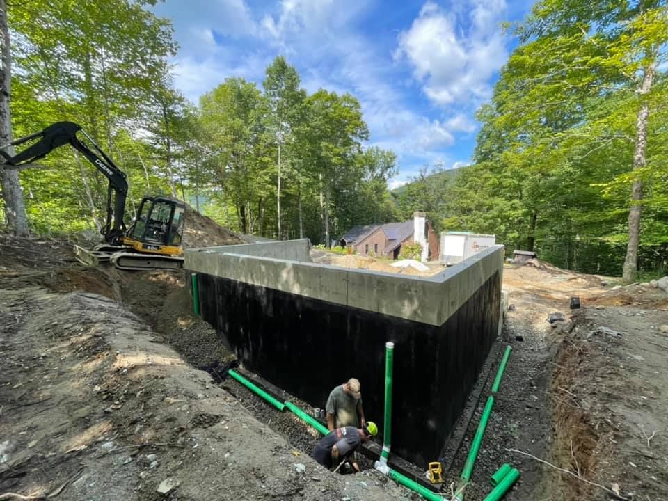 A man is working on a foundation of a house.
