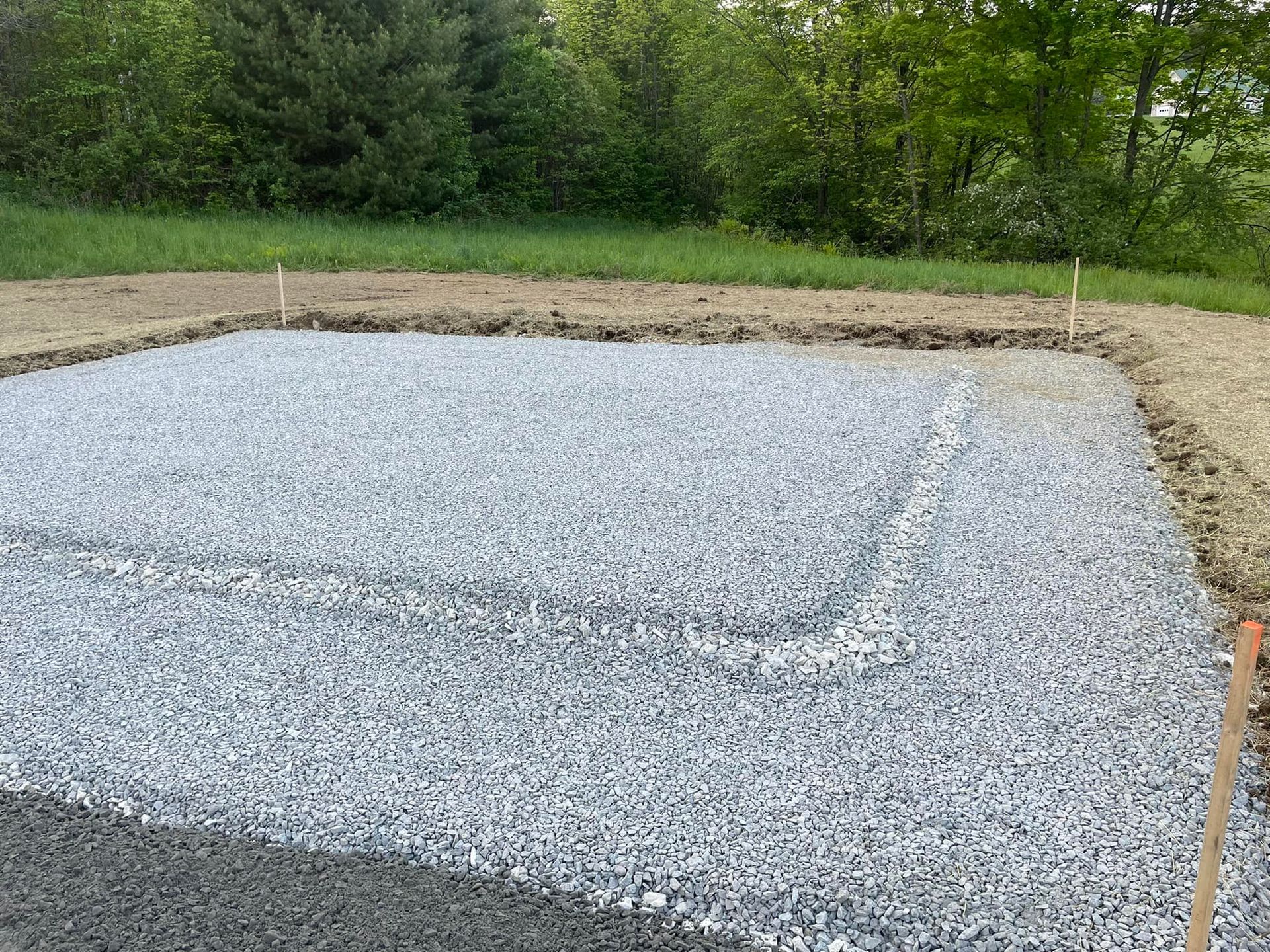 A pile of gravel is sitting on top of a dirt field.