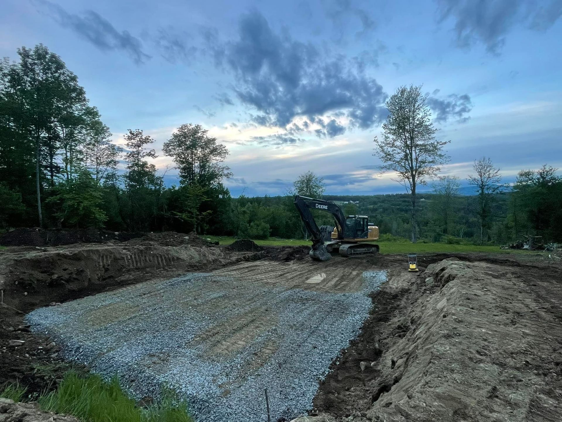 A bulldozer is digging a hole in the dirt in a field.