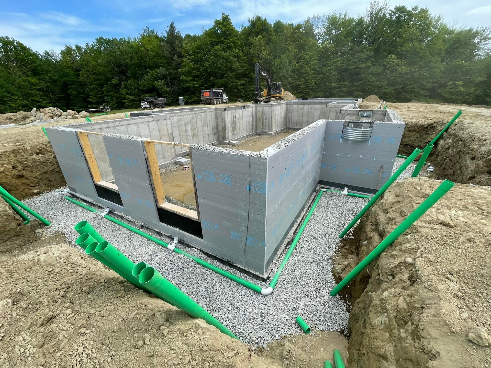 A house is being built in the middle of a dirt field.