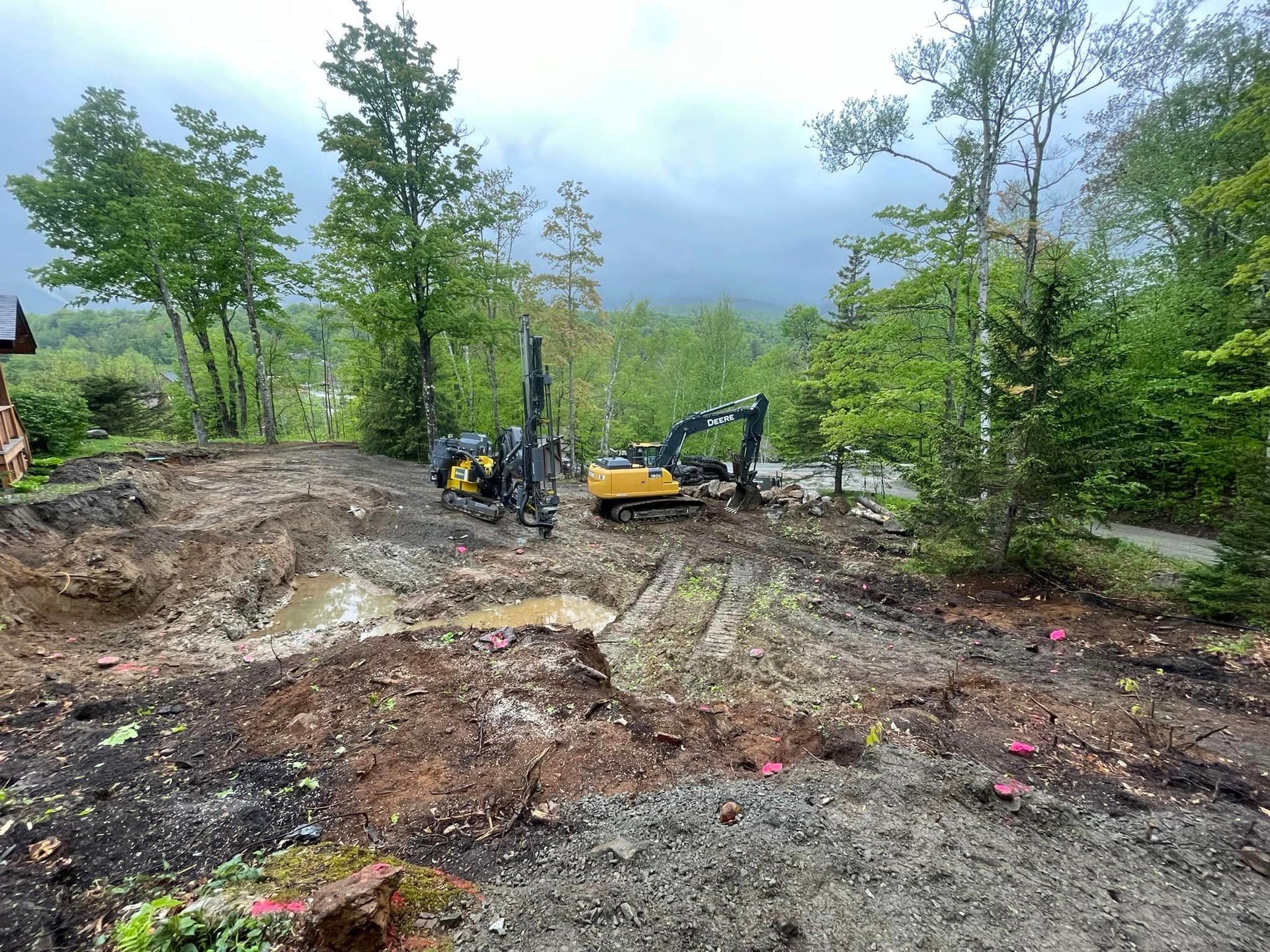 A construction site with a lot of dirt and trees in the background.