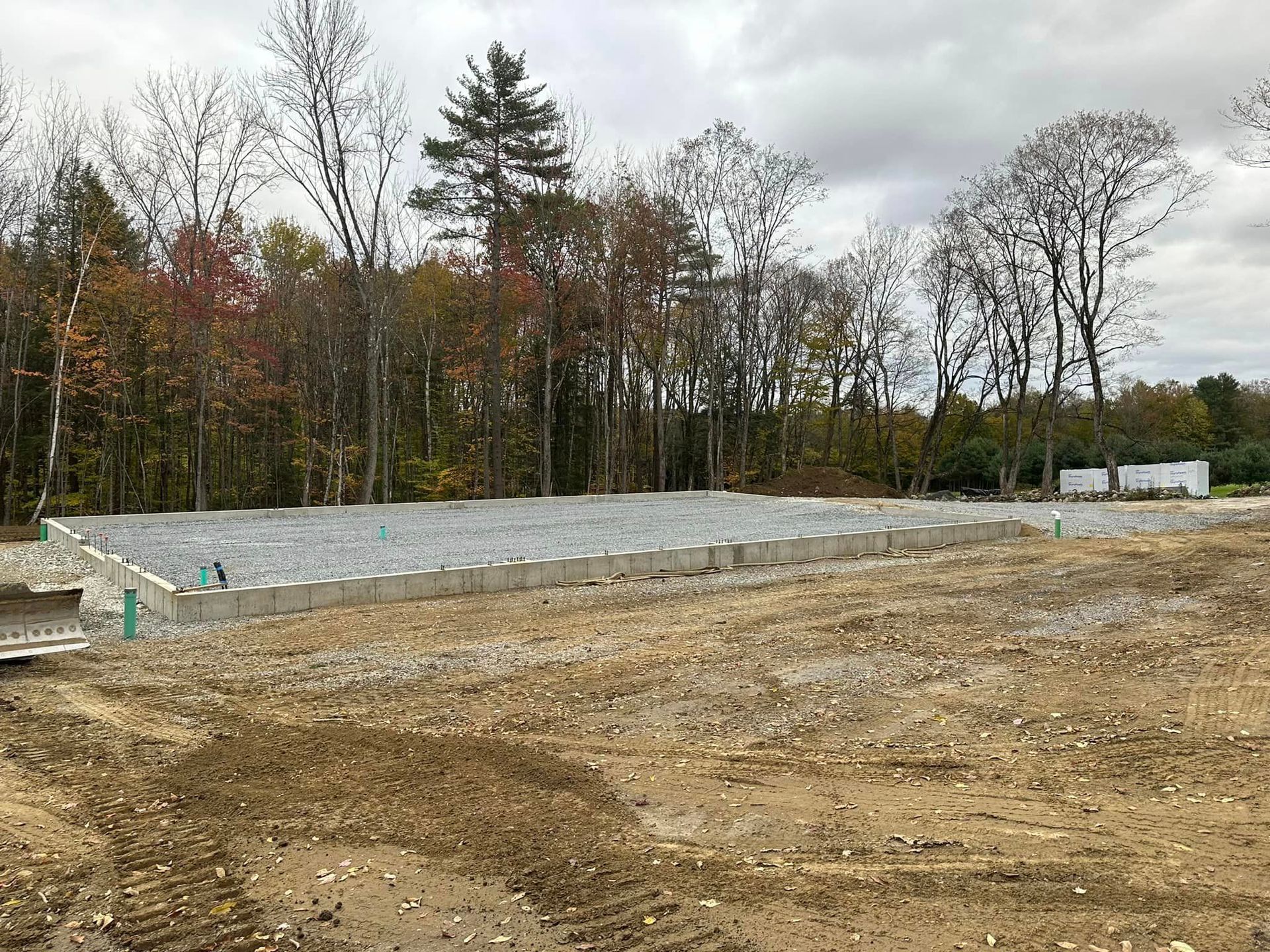 A large dirt field with a lot of trees in the background.