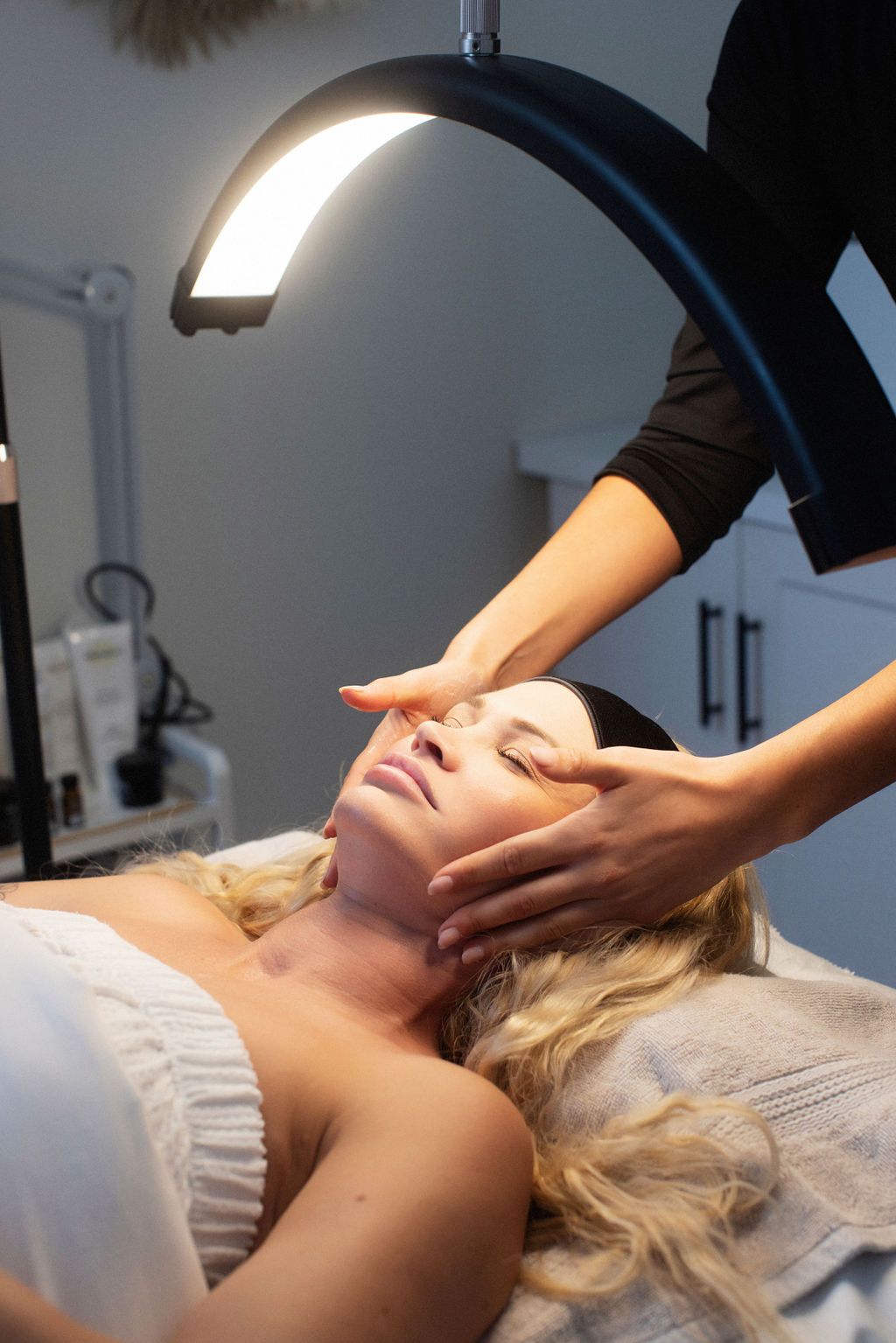 a woman is getting a massage on her face in a spa .