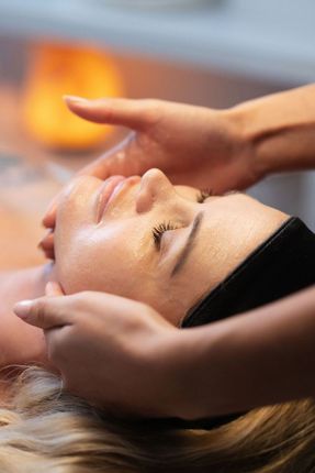 a woman is getting a massage on her face at a spa .