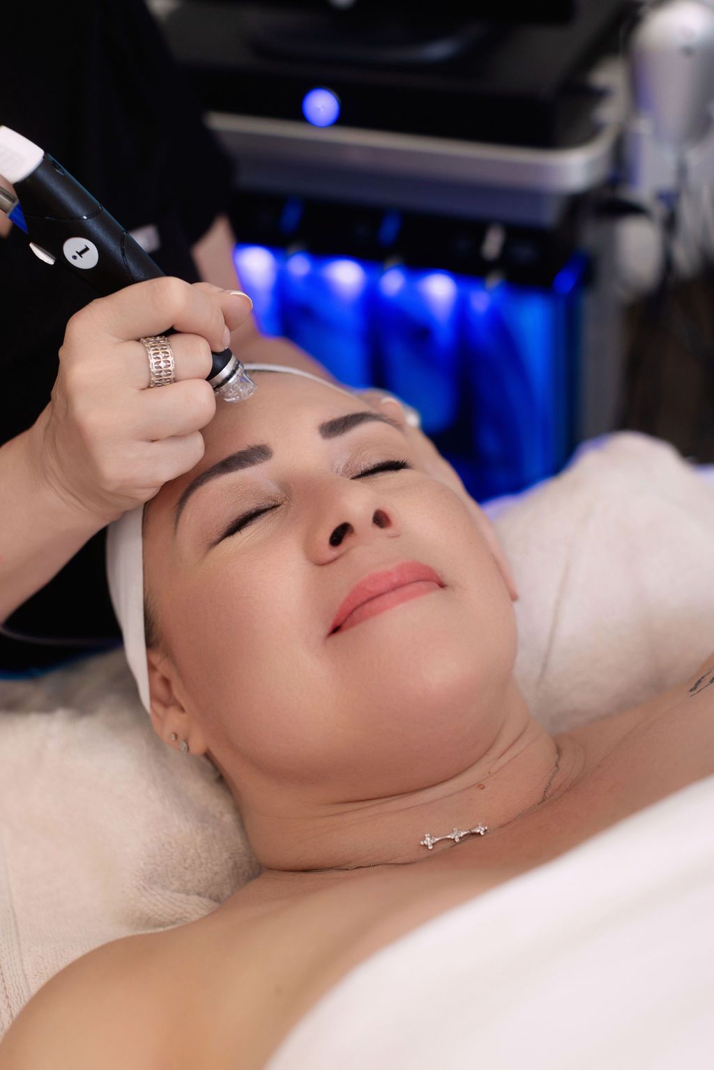a woman is getting a facial treatment at a spa .