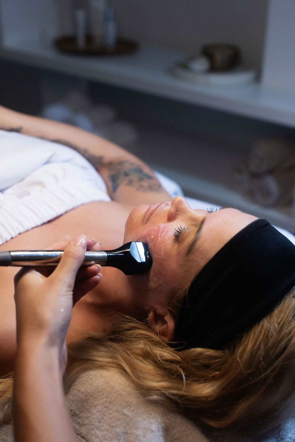 A woman is getting a facial treatment at a spa.