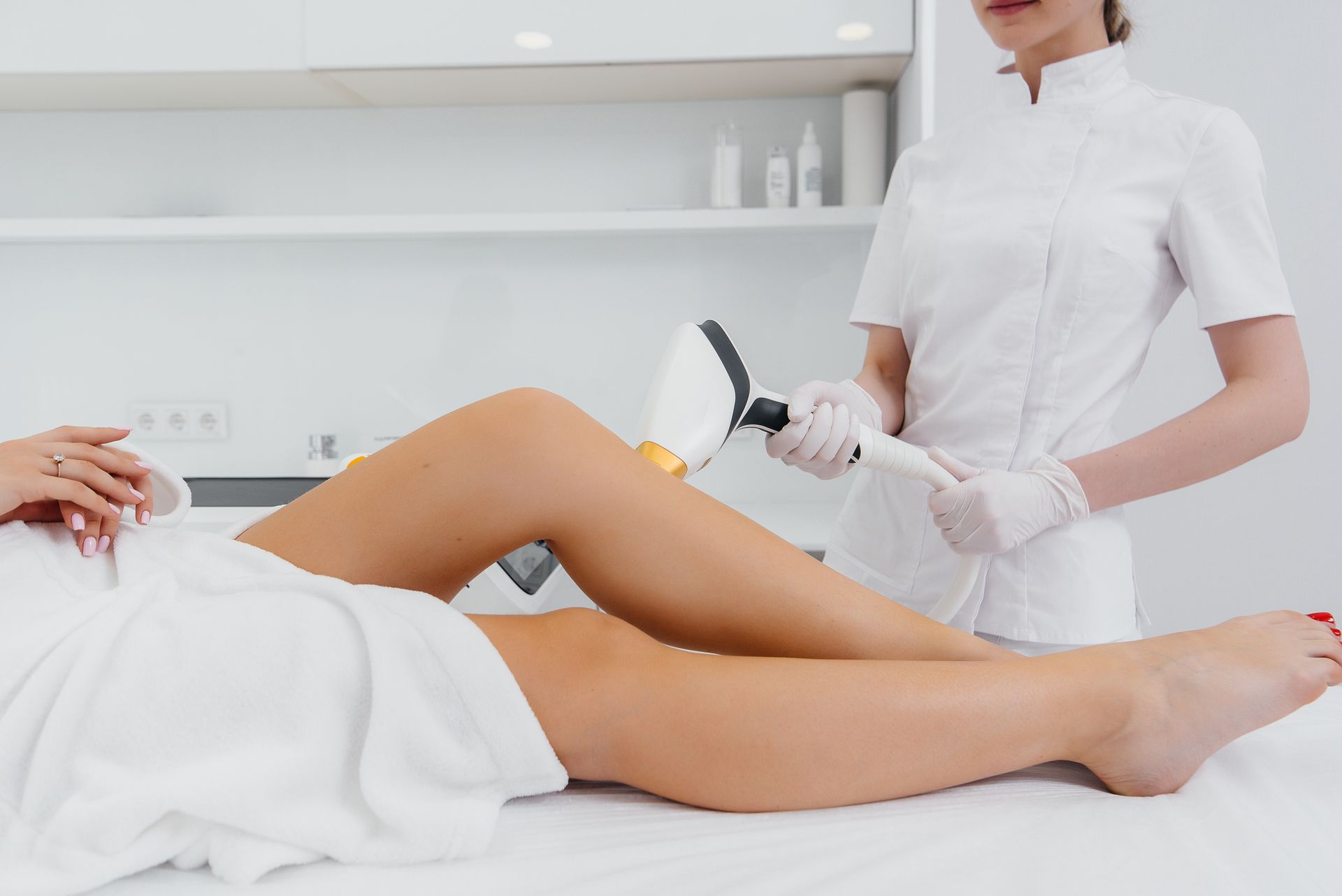 A woman is getting her legs waxed in a beauty salon.