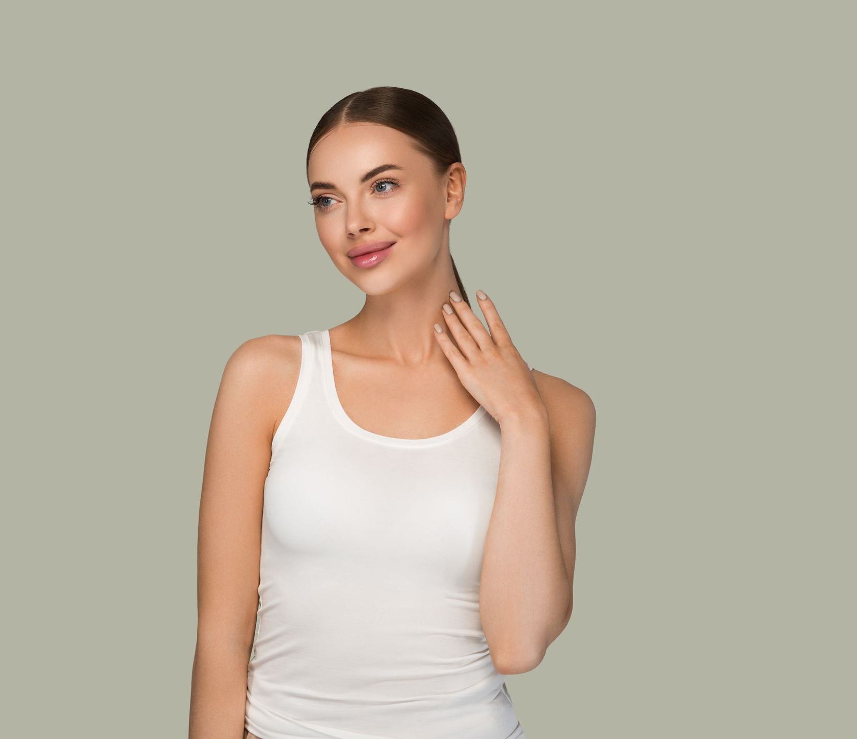 the woman is wearing a white tank top and holding her hand to her neck .
