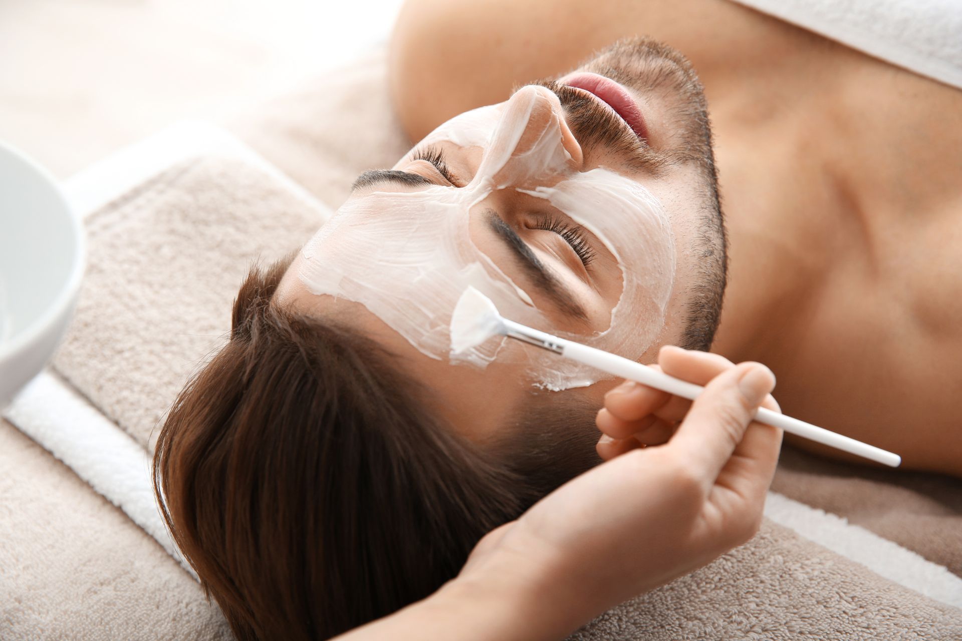 a man is getting a facial treatment at a spa .