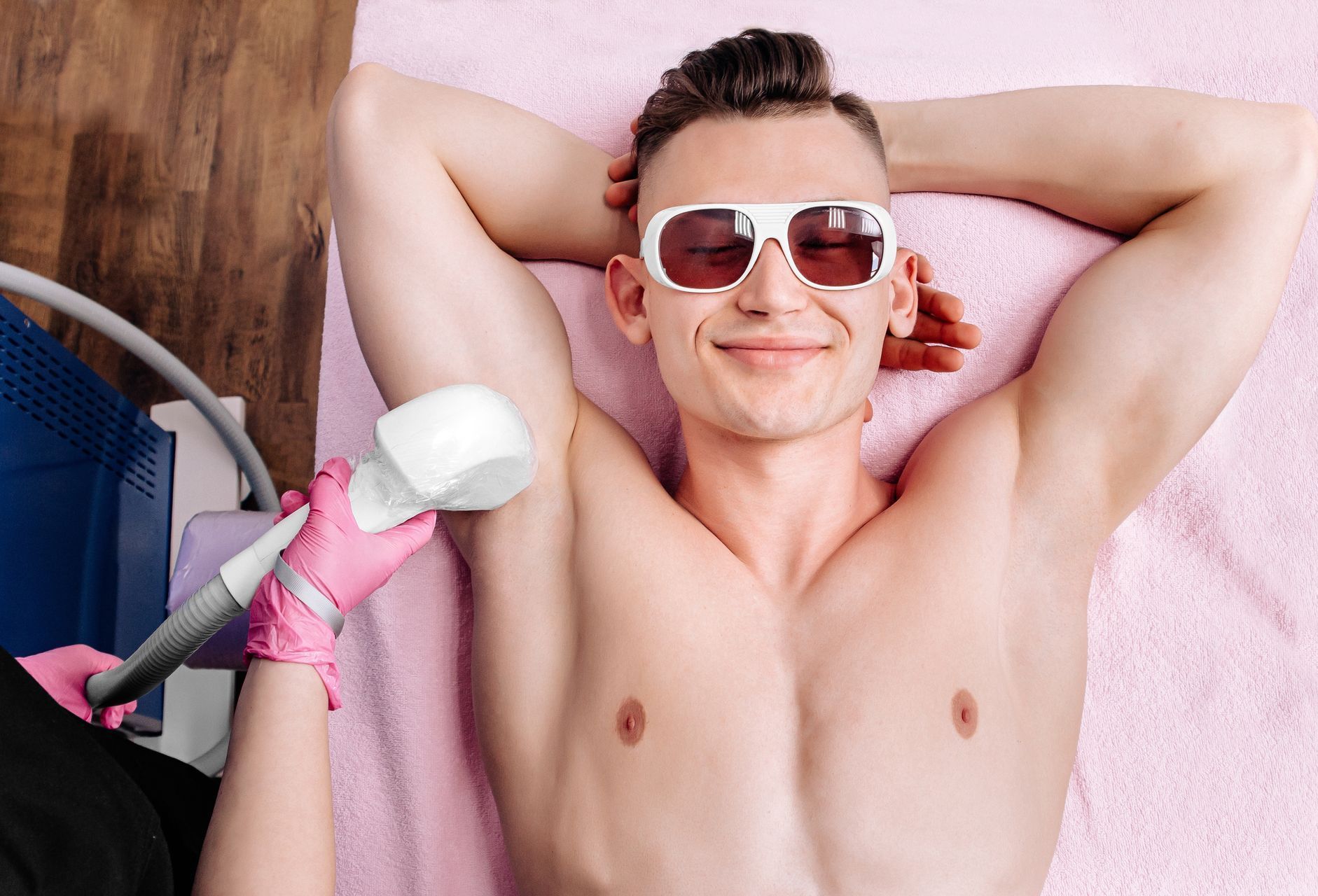 a man is getting a laser hair removal treatment on his armpits .