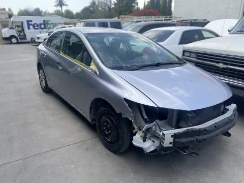 A damaged car is parked in a parking | Northridge Bodyworks