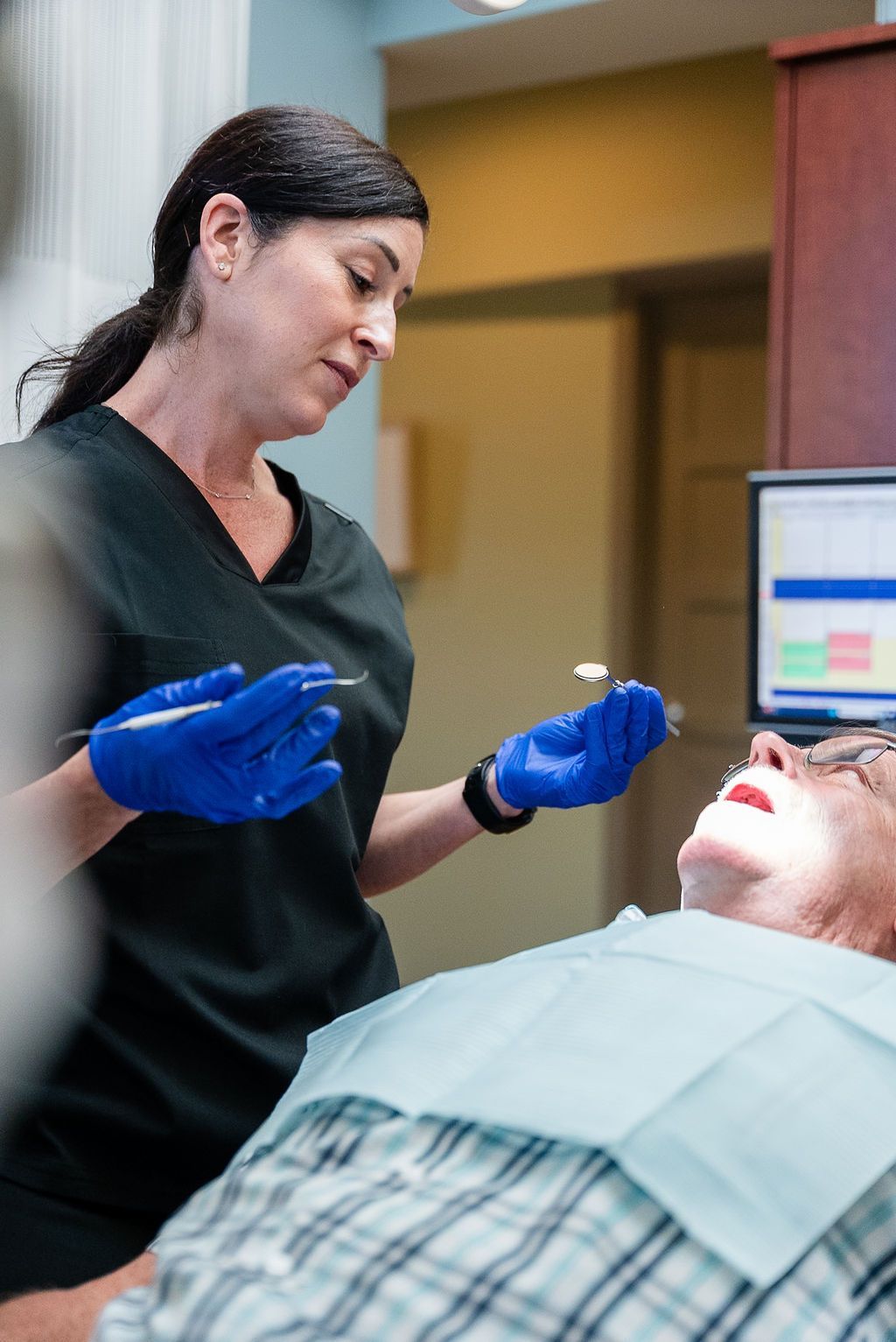 Dental hygienist examining a patient at Robert A. Lantzy DMD, Cleanings & Exams in Newtown, PA