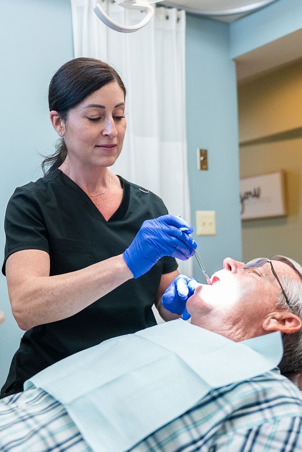 Dental hygienist cleaning a patient's teeth at Robert A. Lantzy DMD, Cleanings & Exams in Newtown, PA