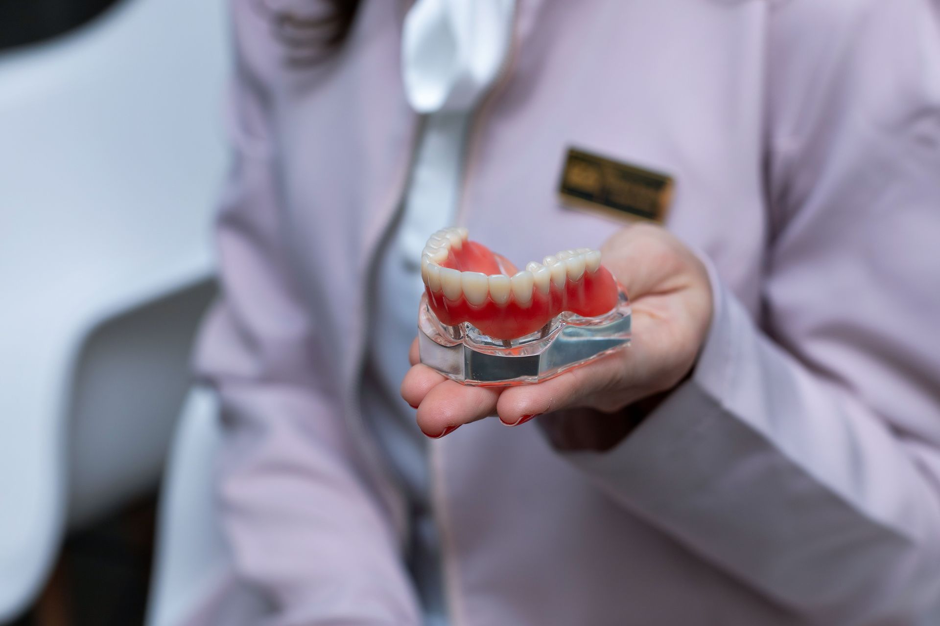 Dentist holding dentures at Robert A. Lantzy DMD, Dentures in Newtown, PA