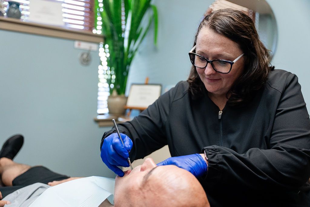 Dentist performing an oral health evaluation at Robert A. Lantzy DMD, Oral-Systemic Health in Newtown, PA