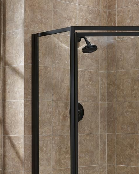 A shower stall with a swinging glass door in a bathroom