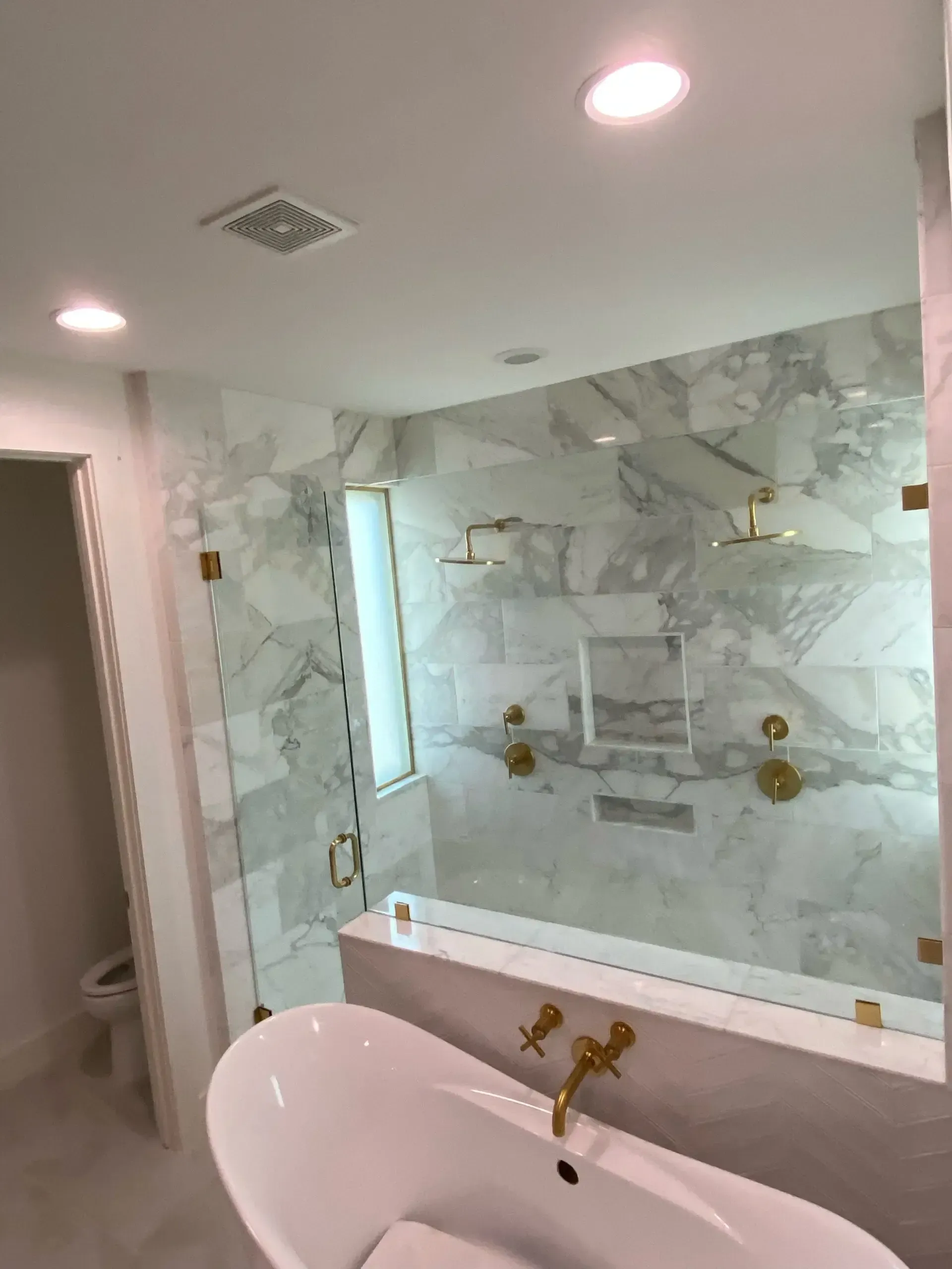 A bathroom with a bathtub and a walk in shower.