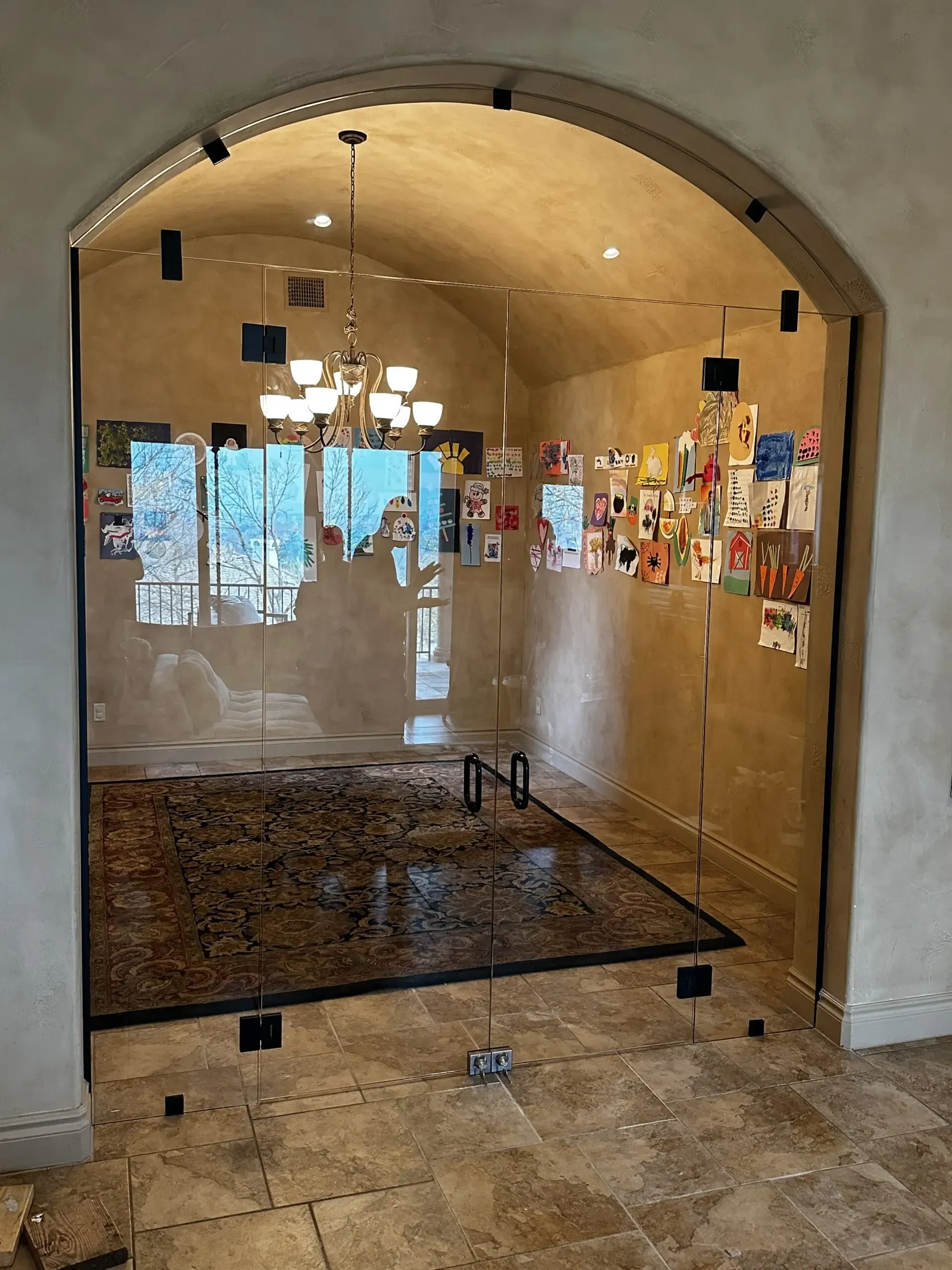 A room with a glass door and a rug in it.