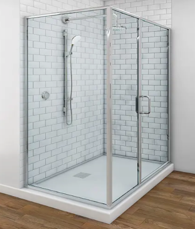 A bathroom with a sliding glass shower door and a sink