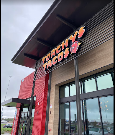 A red building with a sign that says torchy 's tacos