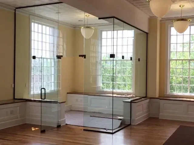 A room with a lot of windows and glass doors