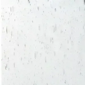 A close up of a white surface with water drops on it.