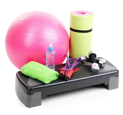An exercise step, fitness ball, skipping rope, weights, a bottle of water and a rolled-up mat