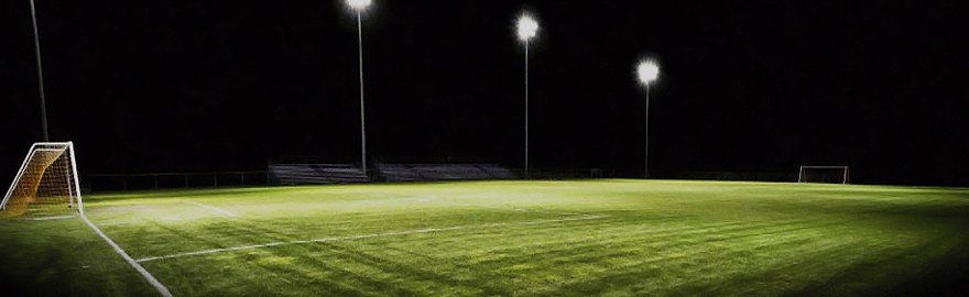 An empty, floodlit football pitch