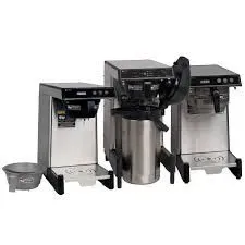 Three commercial coffee machines on a counter, with a steel drip tray.