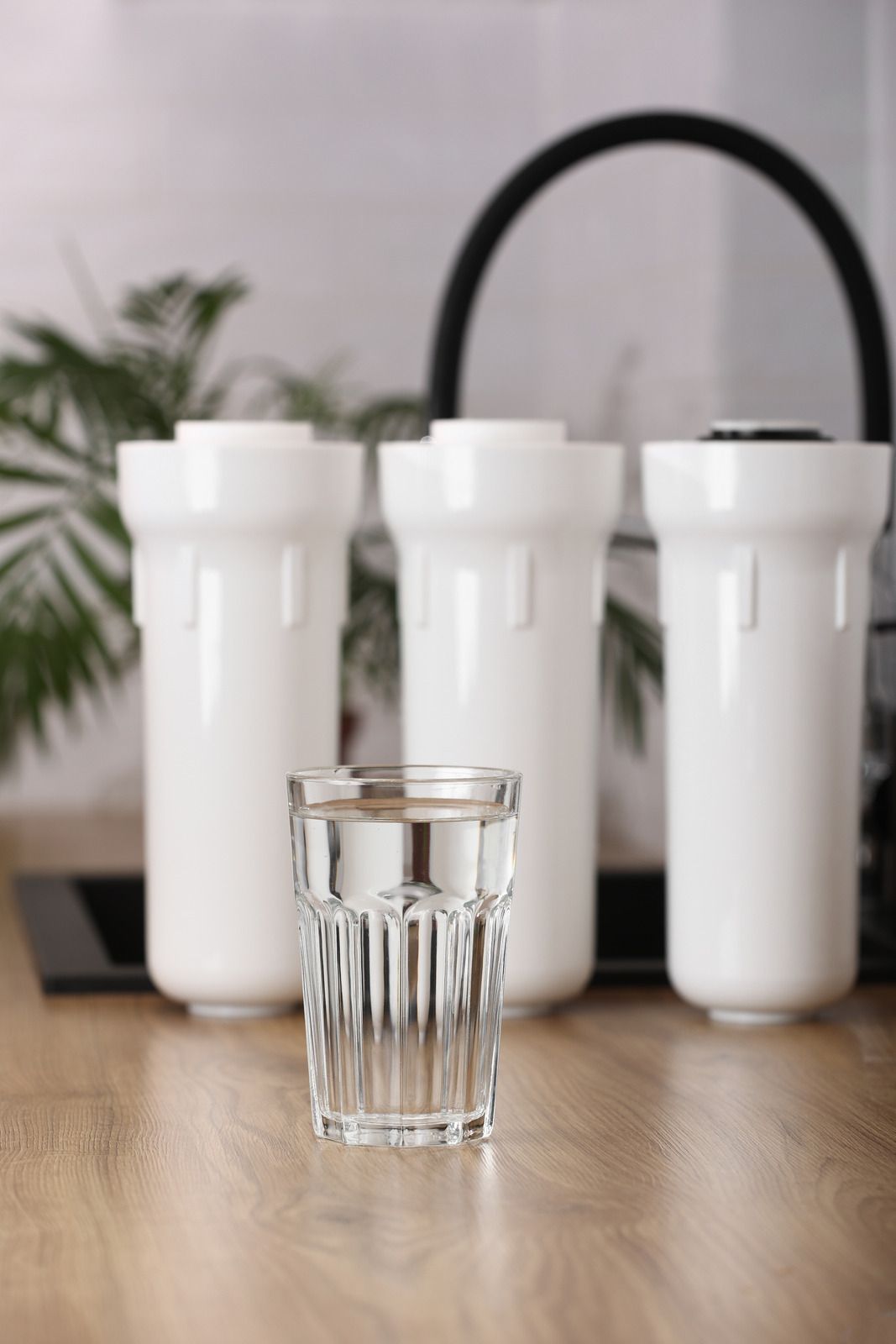 A yellow excavator is sitting on top of a pile of gravel.