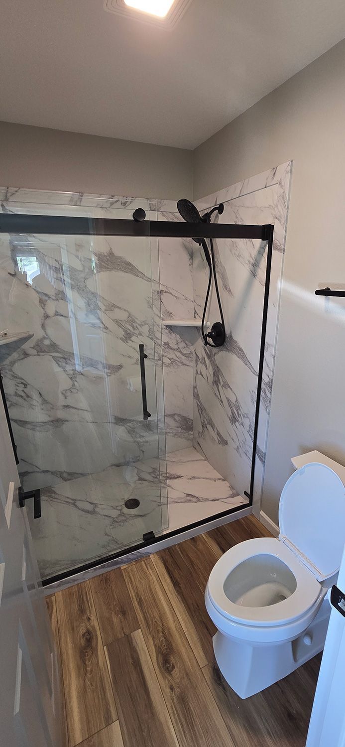 Shower room, toilet and wooden floor in bathroom