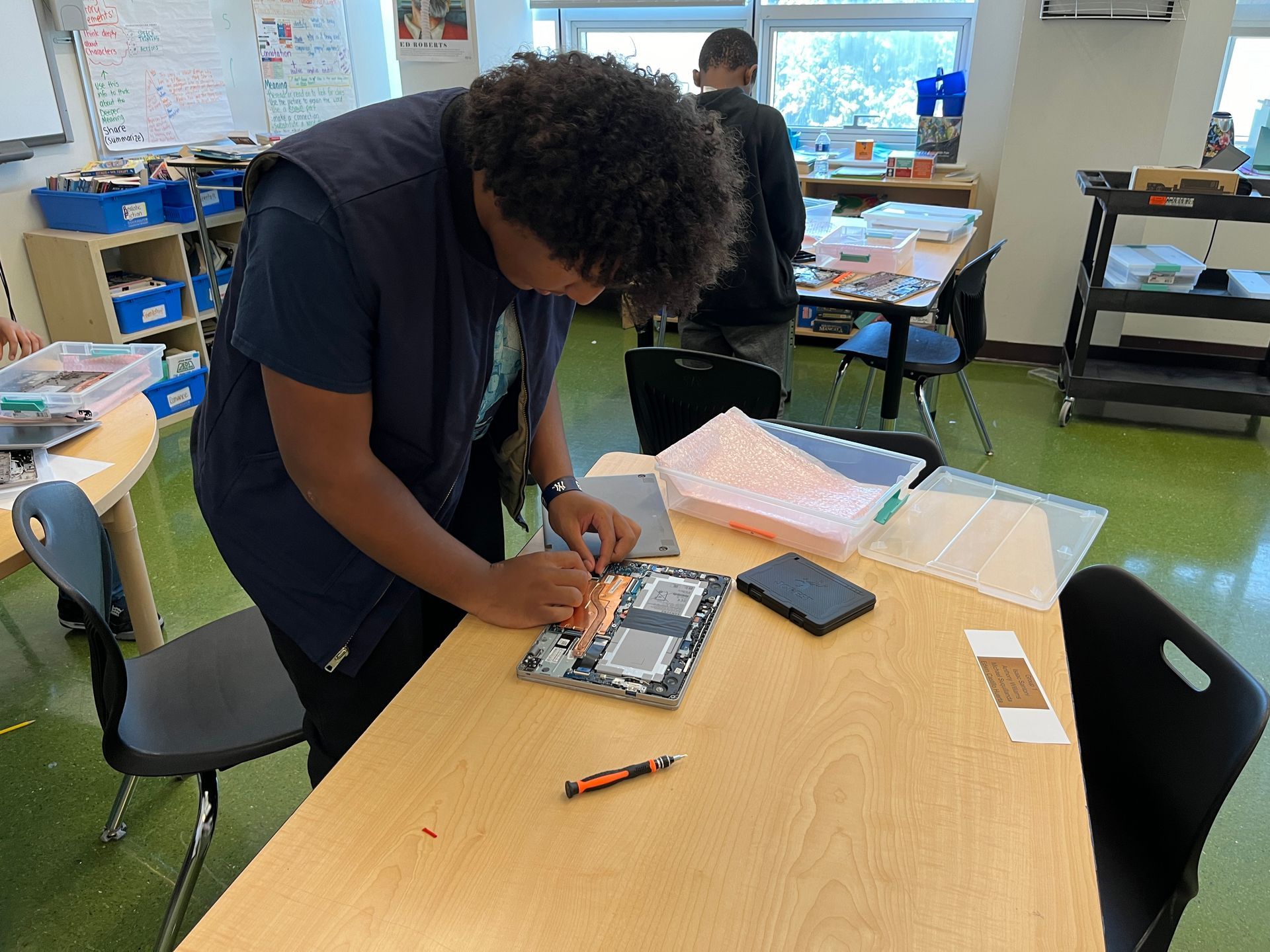 A man is working on a piece of paper on a table