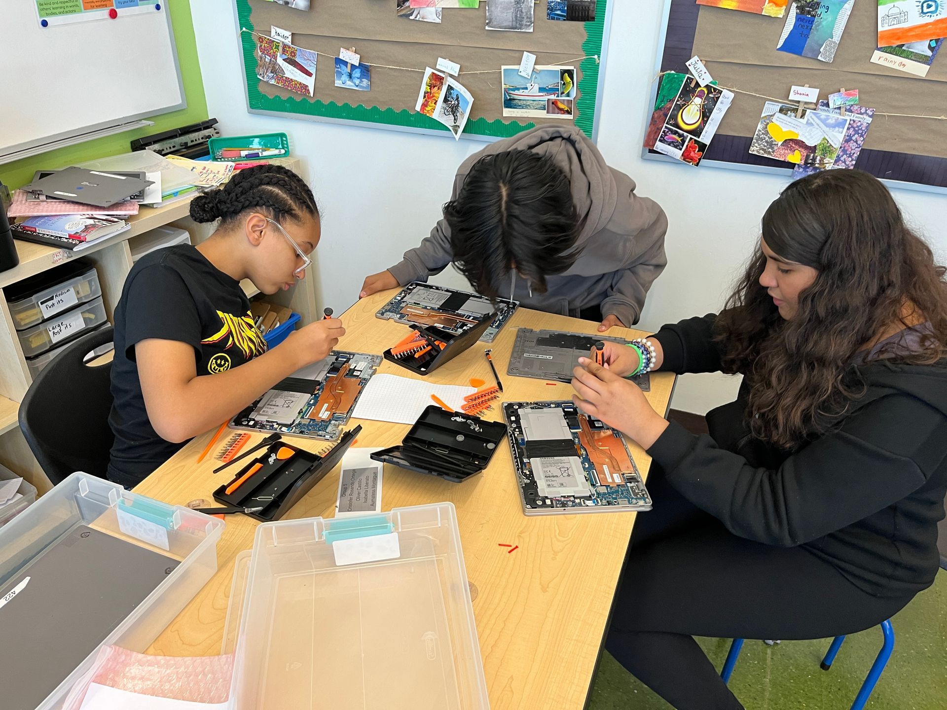 A group of girls are working on a laptop computer