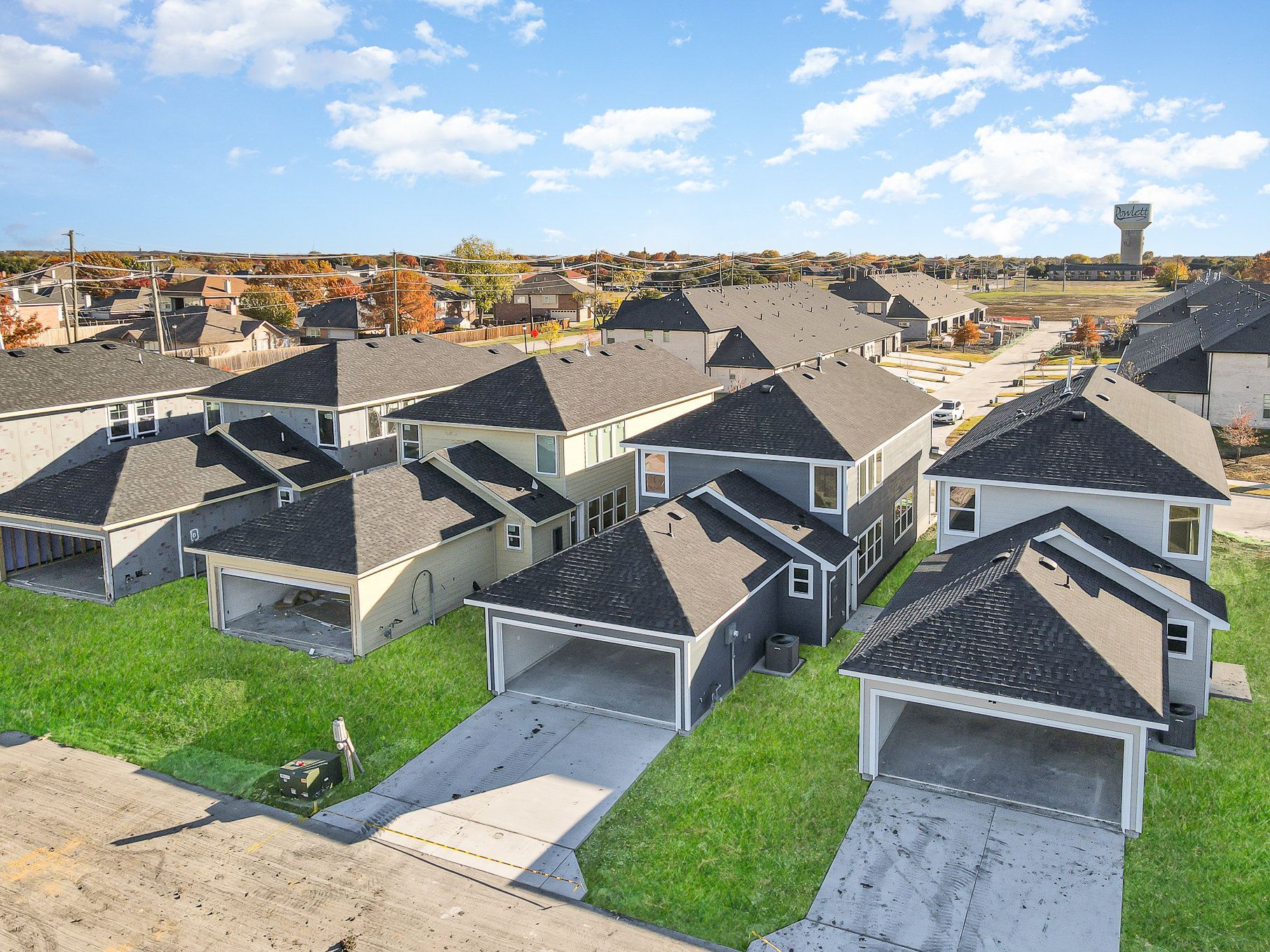 An aerial view of a residential neighborhood with lots of houses and garages.