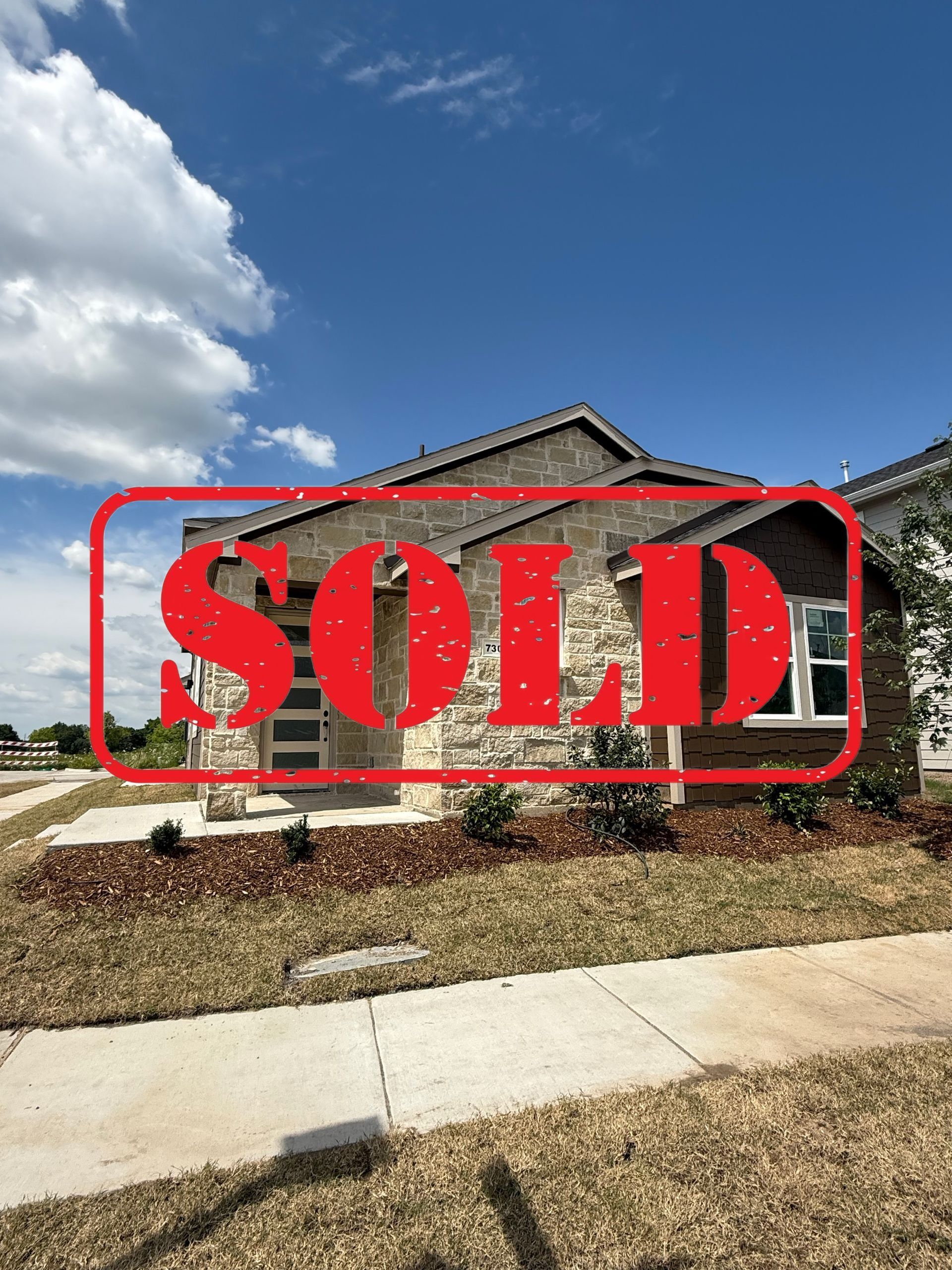 An artist 's impression of a house with a black roof and white siding.