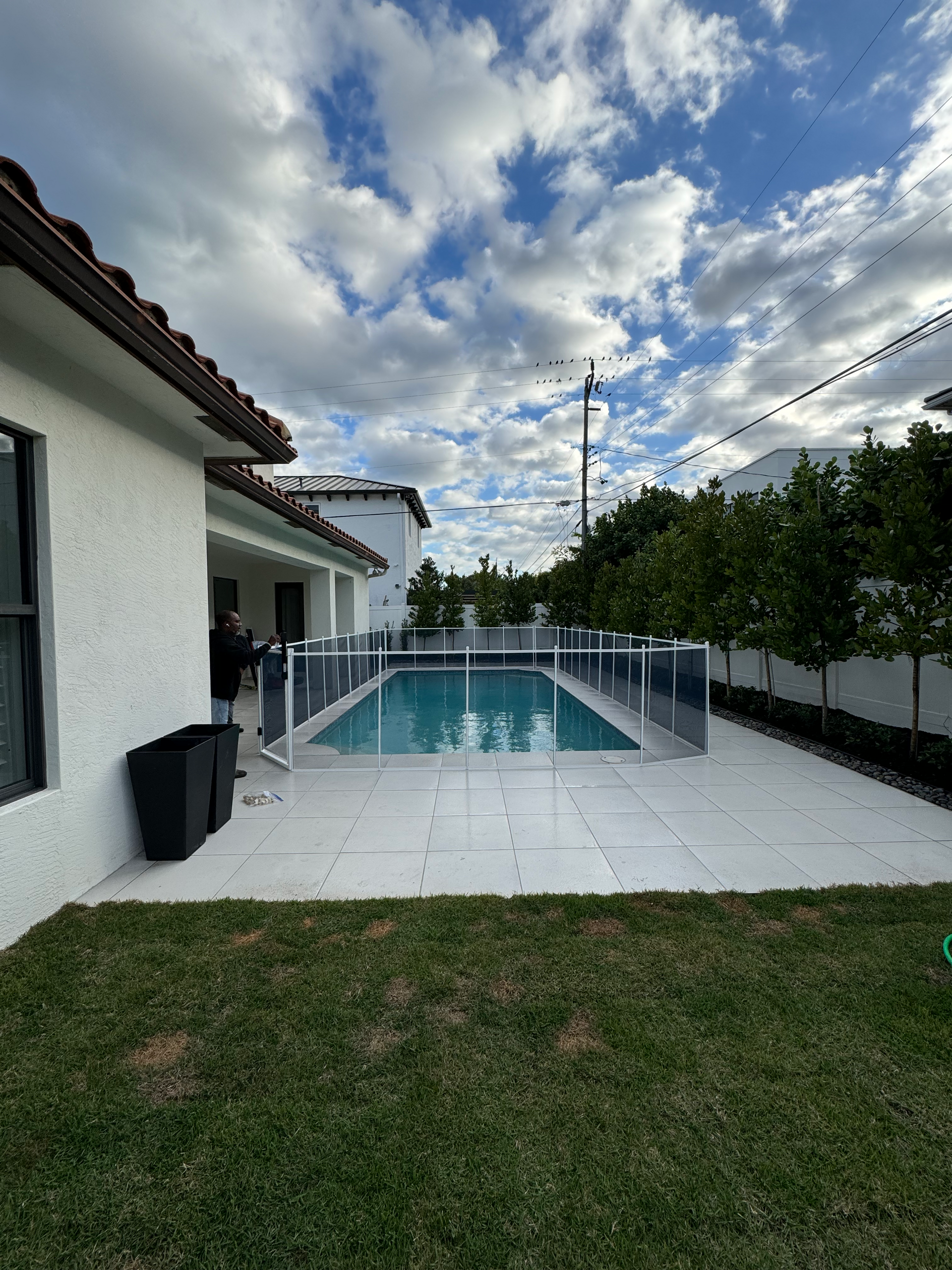 there is a large swimming pool in the backyard of a house .