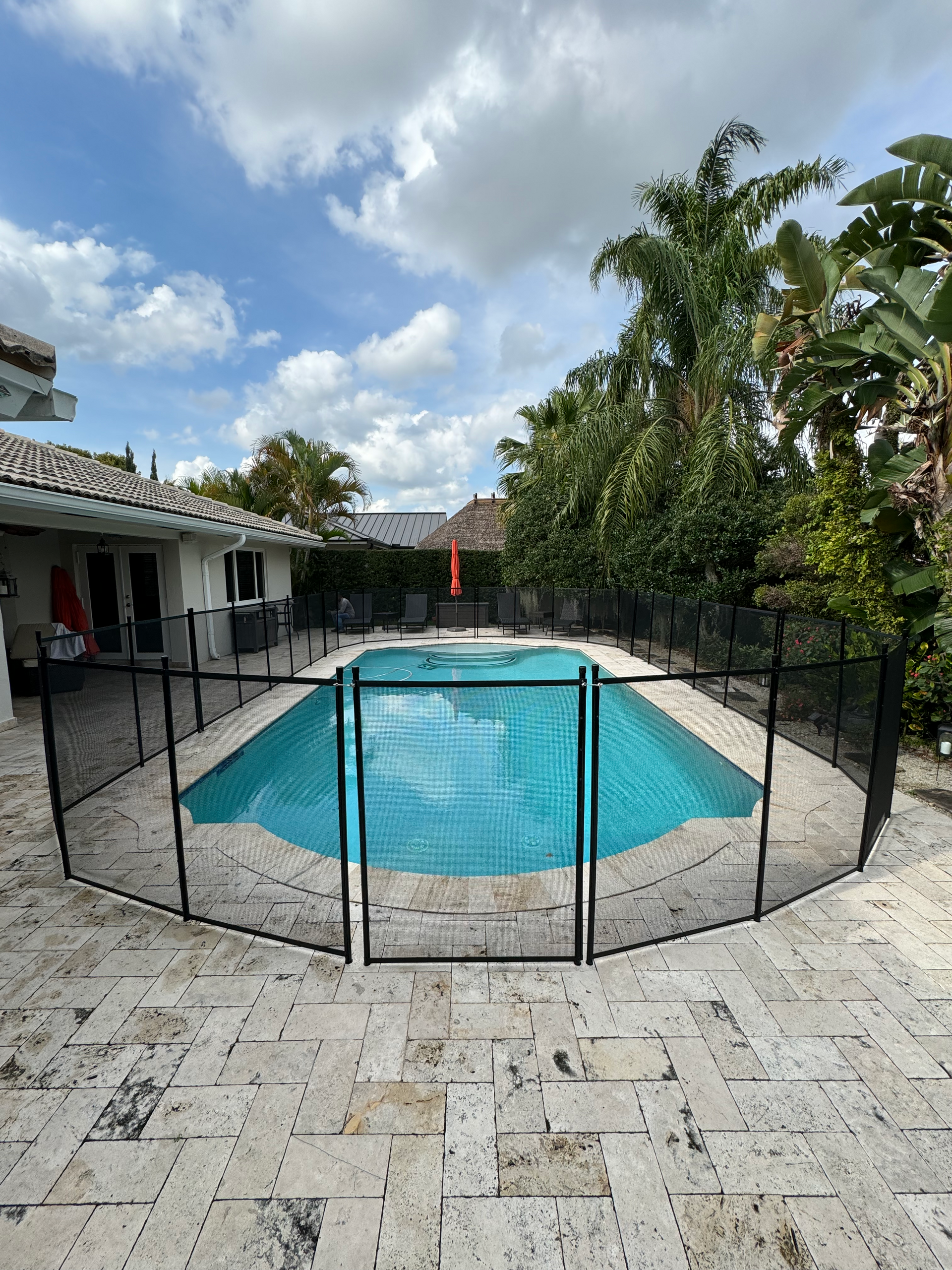 a swimming pool with a black fence around it .