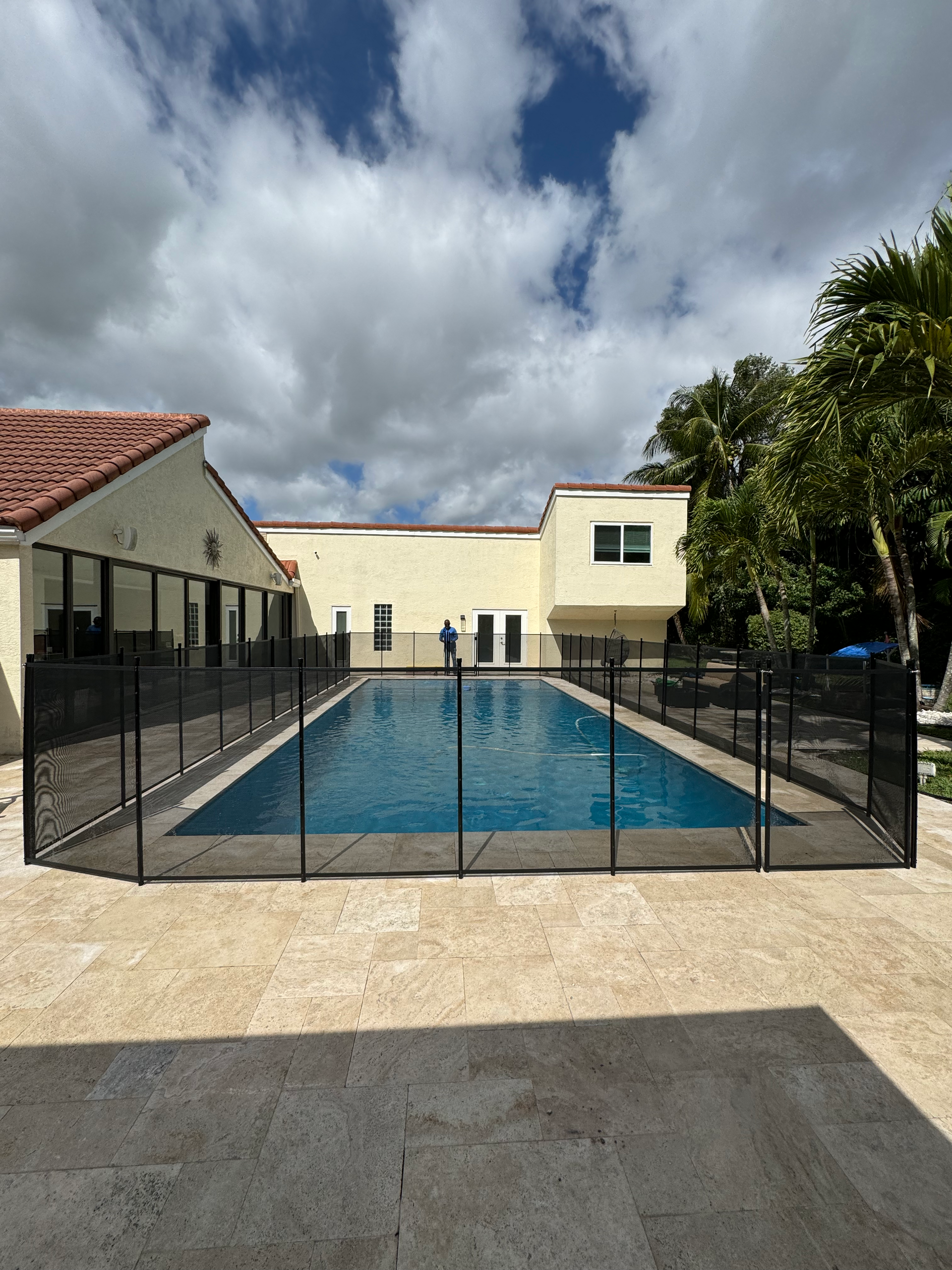 A large swimming pool with a fence around it